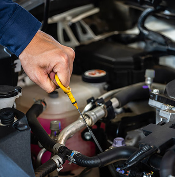 hand of technician checking the oil level